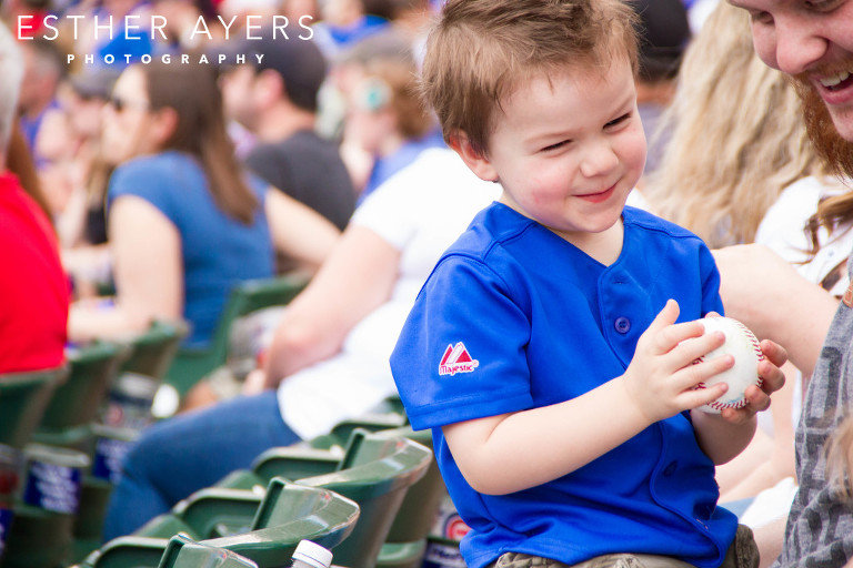 little boy at a baseball game at wrigley field in chicago