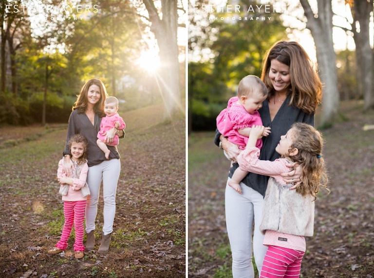 Beautiful mom and her two girls in a park at sunset