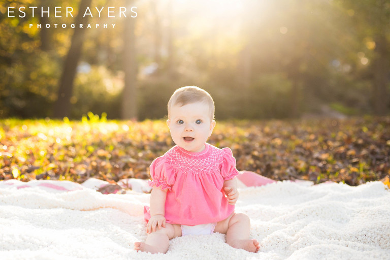 baby girl on a blanket at sunset