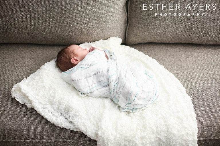 newborn baby boy on couch wrapped in a blanket - esther ayers photography