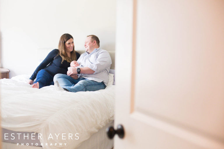 Newborn Baby Boy with Smiling First Time Mom and Dad in Master Bedroom