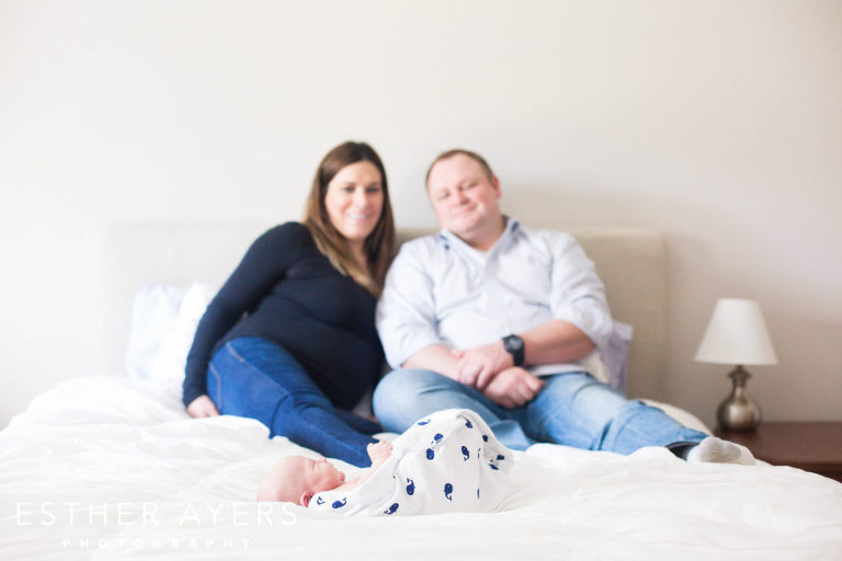 Newborn Baby Boy with Smiling First Time Mom and Dad in Master Bedroom