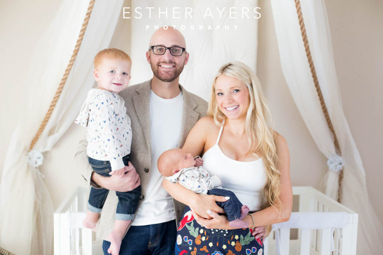 Newborn Baby Boy with Mom and Dad and big brother in Nursery