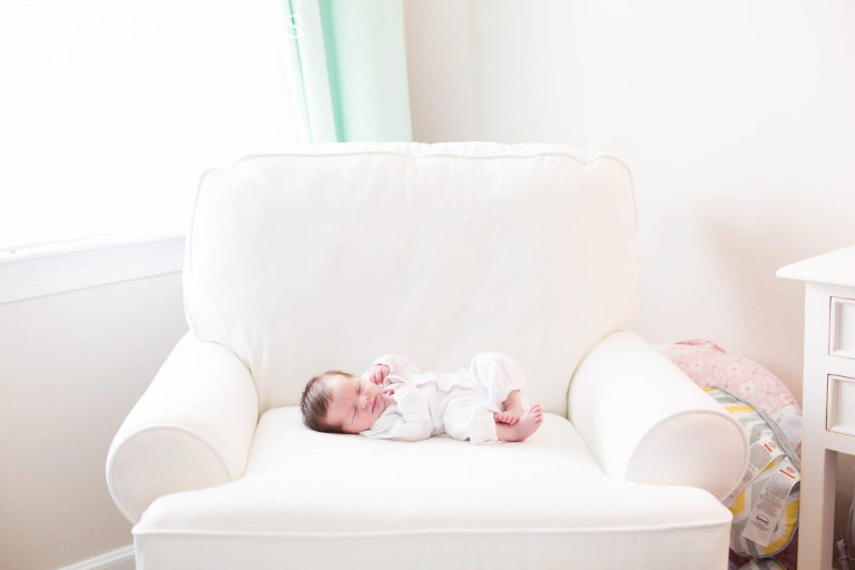 Newborn Baby Girl on chair in nursery