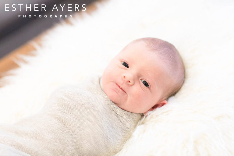 Newborn Baby Girl smiling on faux fur