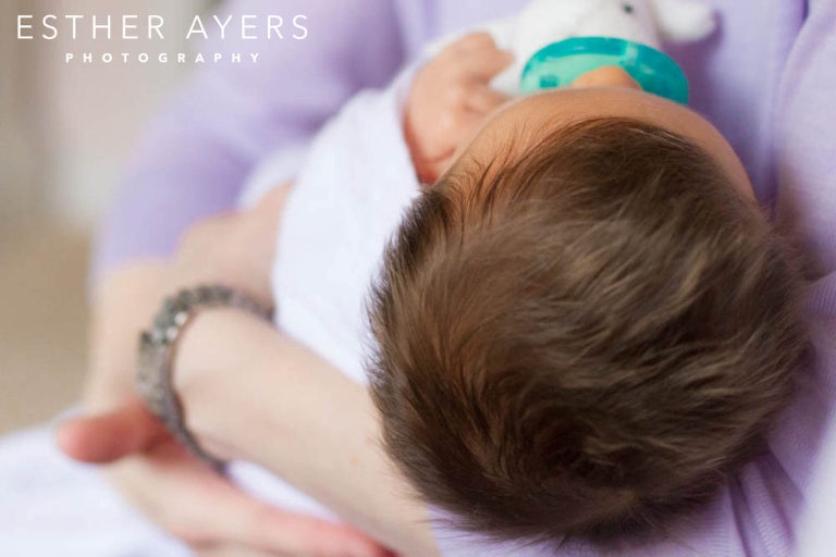 Mom holding Newborn Baby Girl wrapped in blanket