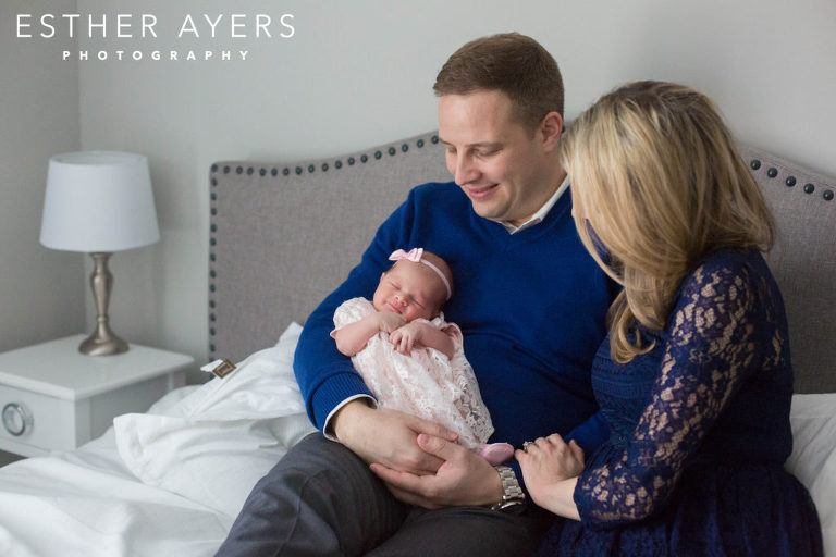 mom and dad looking at newborn baby girl