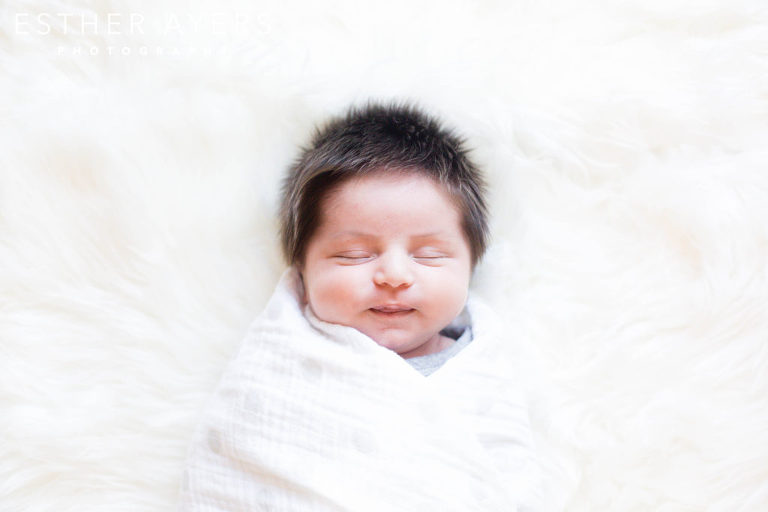 newborn baby boy on faux fur rug