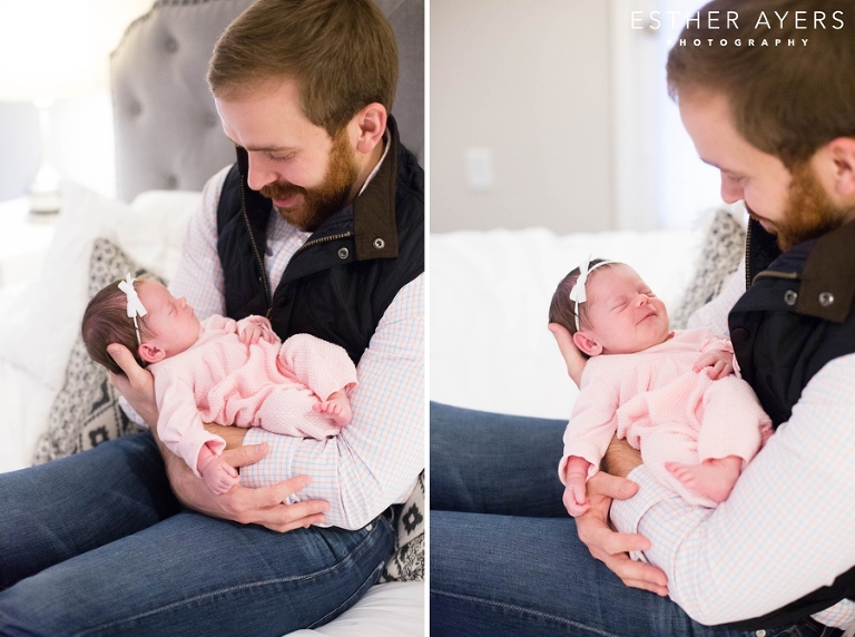 dad smiling at newborn baby girl