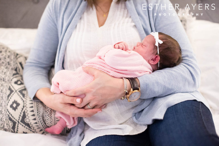 newborn baby girl being held by mom