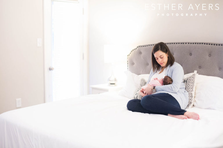mom with newborn baby girl on bed