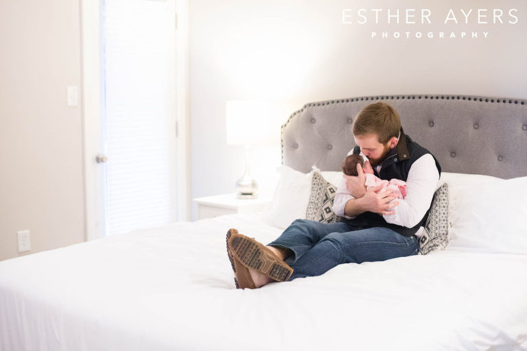 dad kissing newborn baby girl